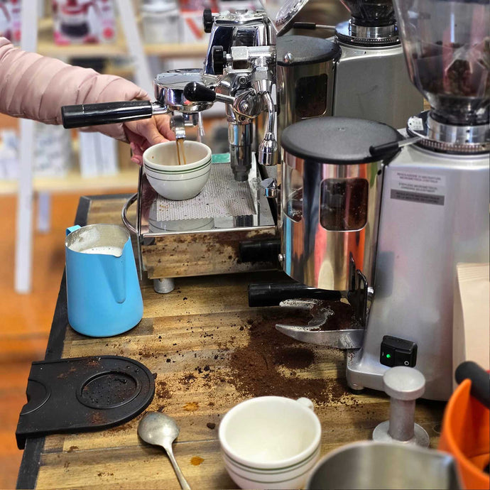 learning how to make espresso coffee on a home coffee machine and grinder