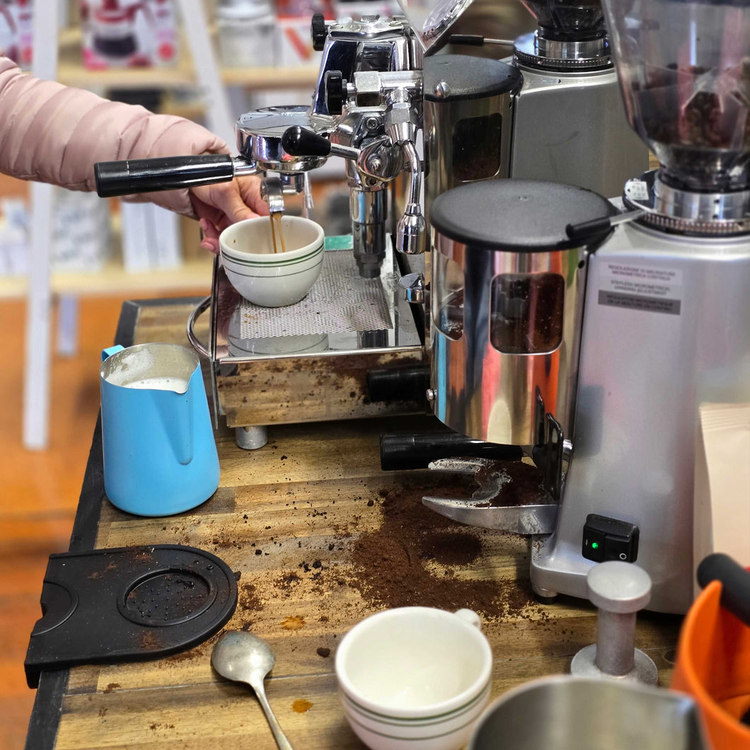 learning how to make espresso coffee on a home coffee machine and grinder