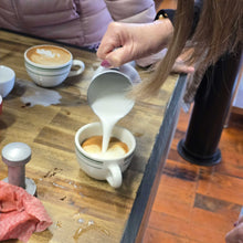 Load image into Gallery viewer, person learning how to pour a flat white coffee in our home barista training program
